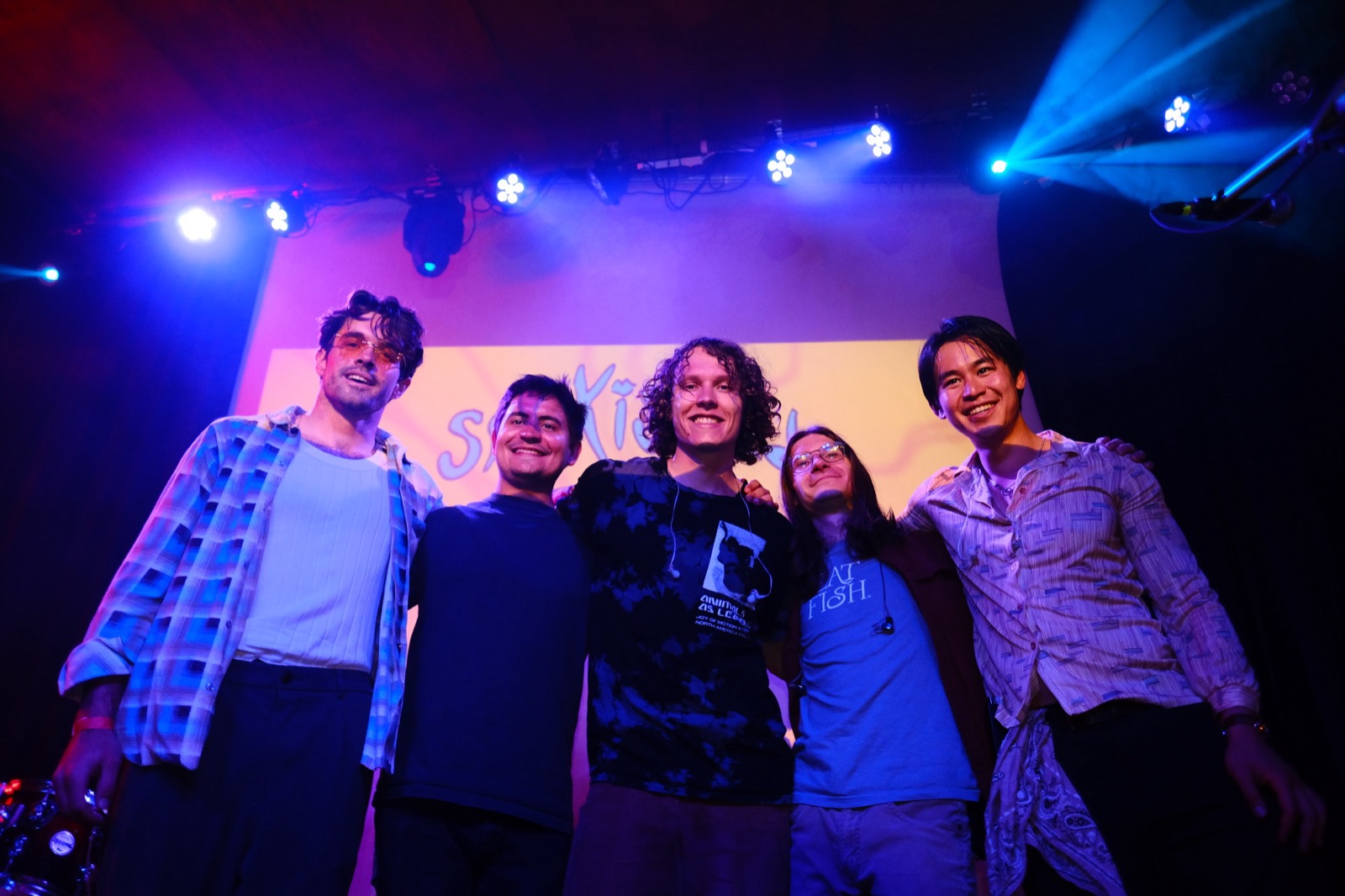 Band on stage together after a show