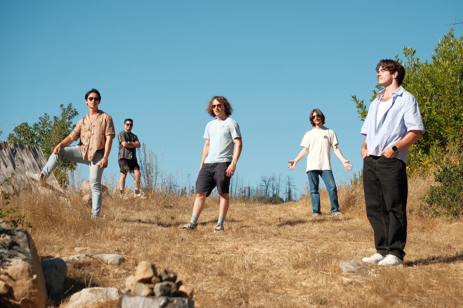 Band standing on a hilltop in golden hour light