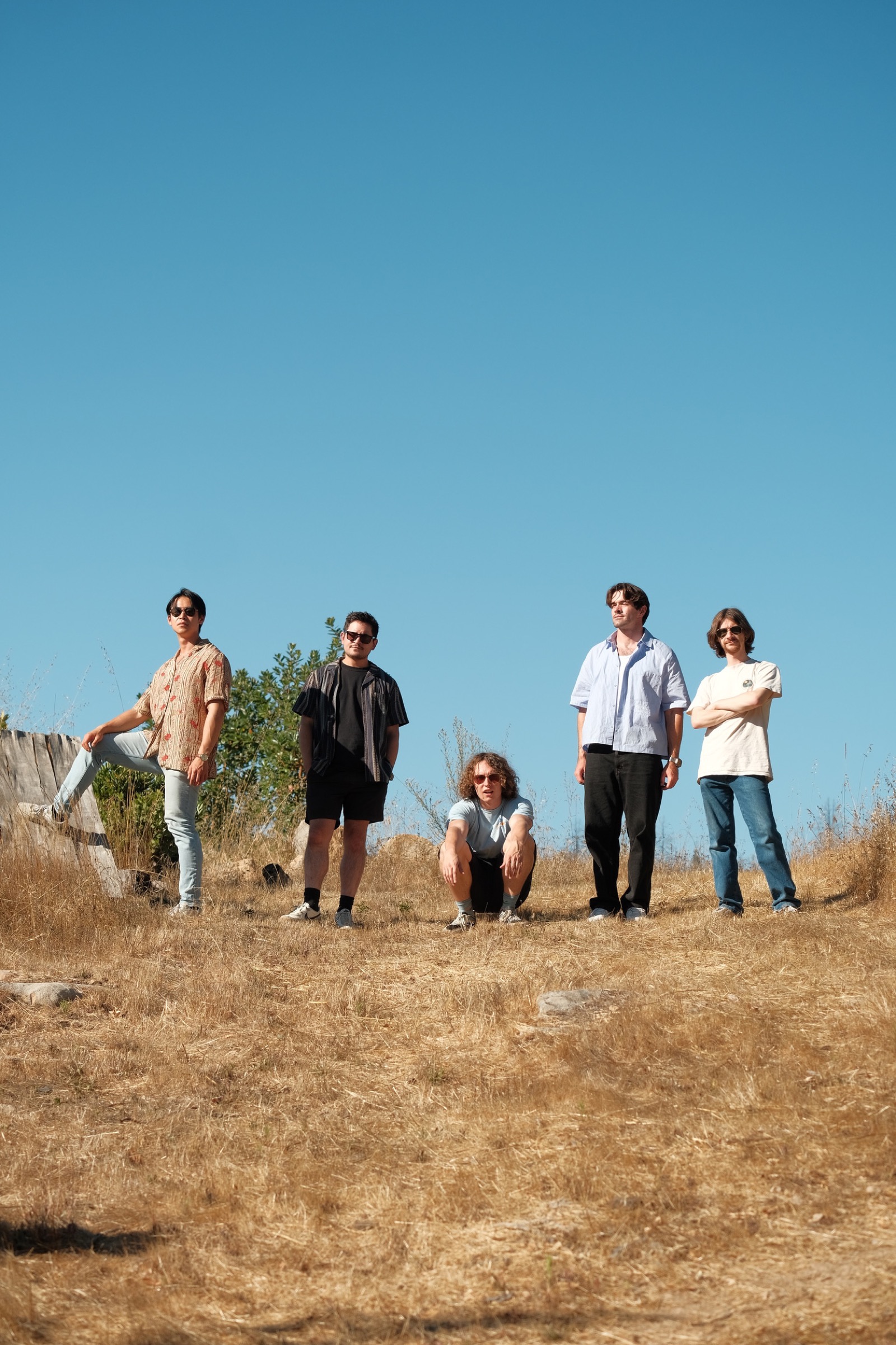 Band portrait on a dry hillside under blue sky