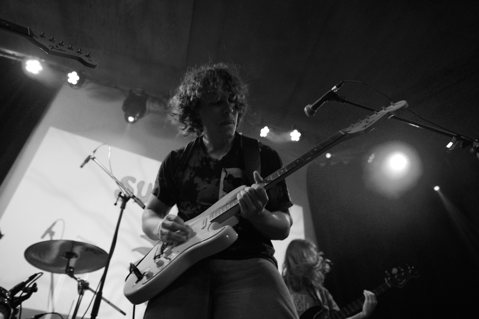 Guitarist shredding on stage in black and white
