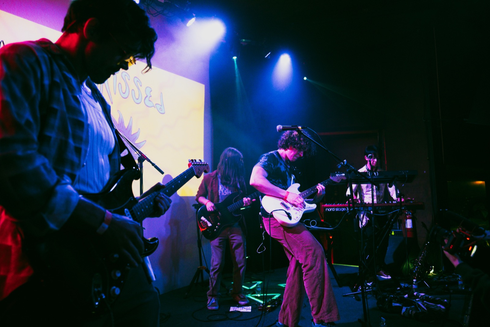 Saxophonist playing under red stage lighting